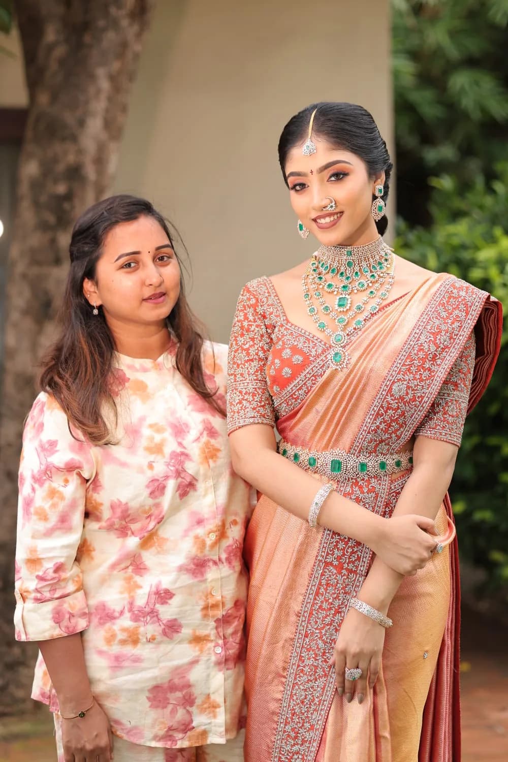 Two guests styled in coordinated sarees