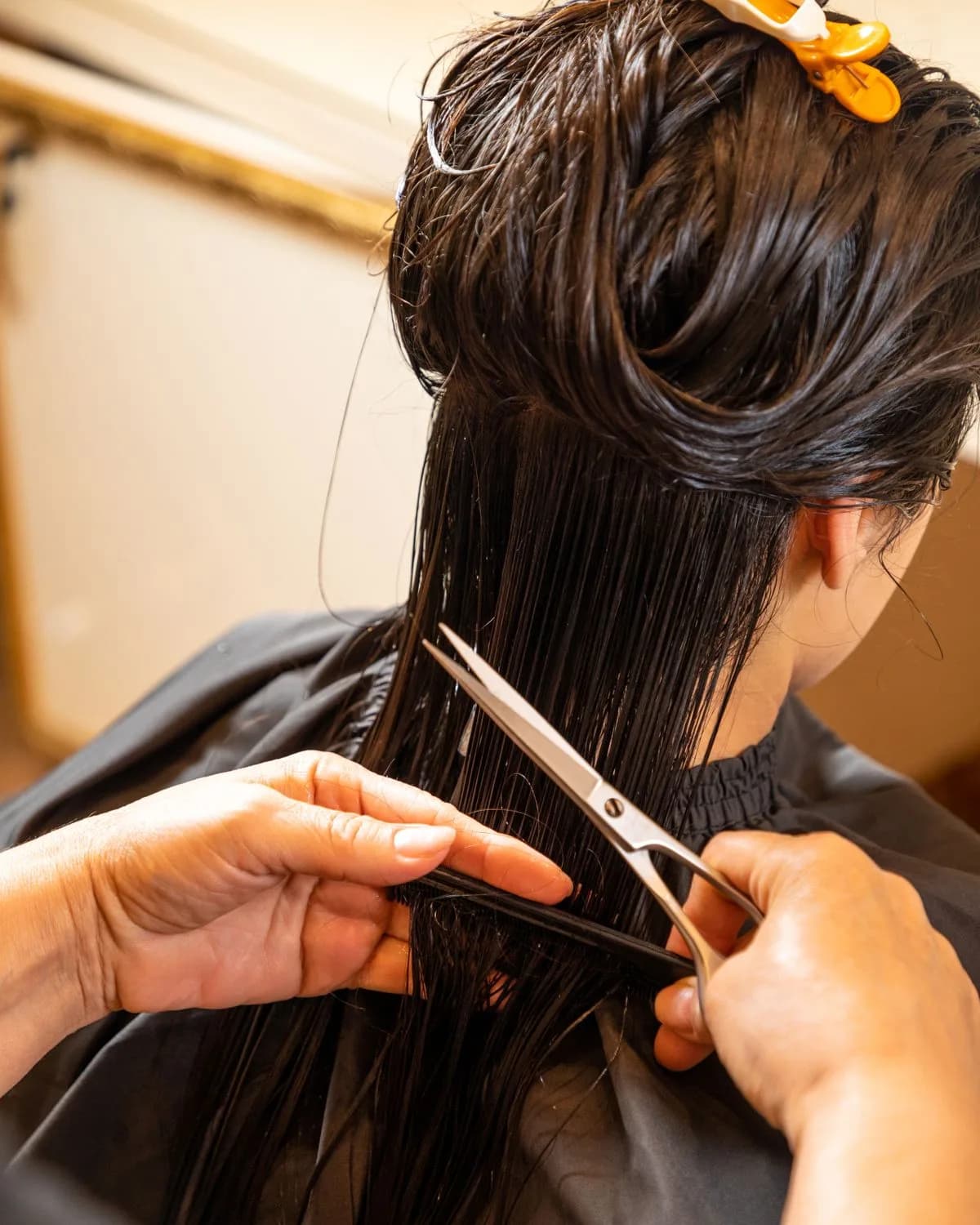 Student practising a precision haircut during academy training