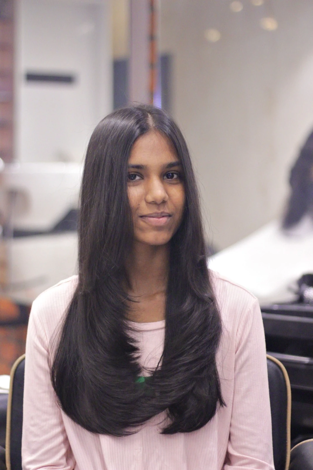 Long, glossy layered hair styled to perfection