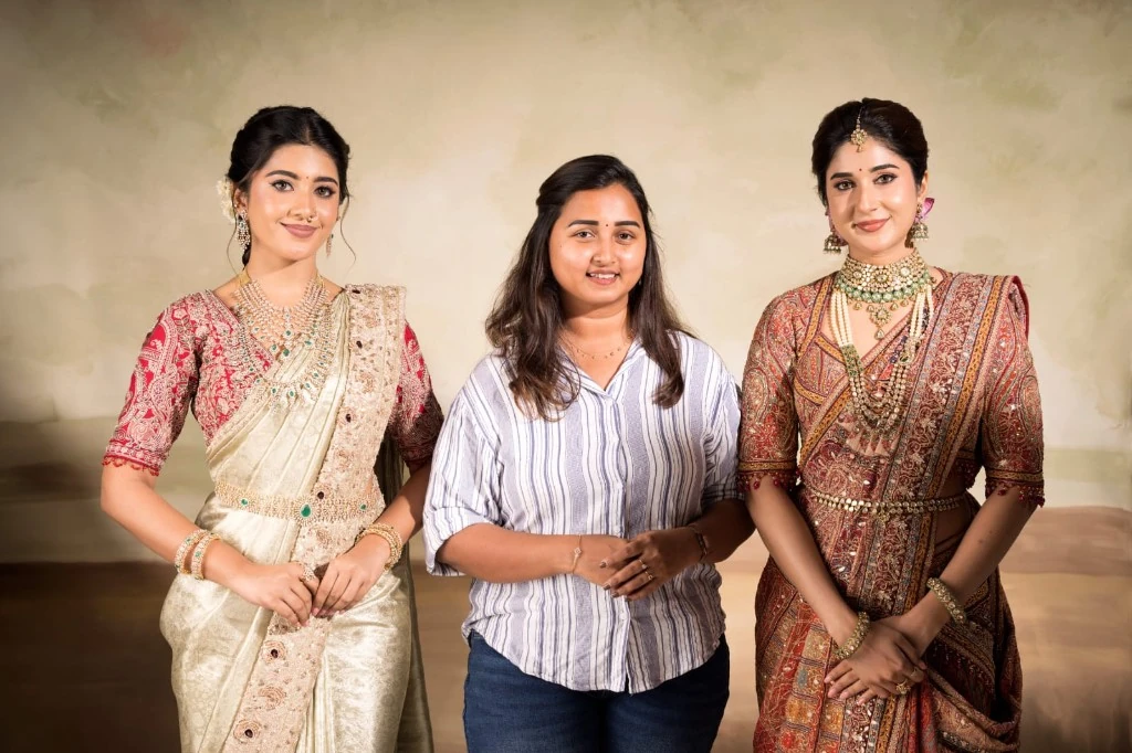 Two brides in traditional bridal looks with their makeup artist