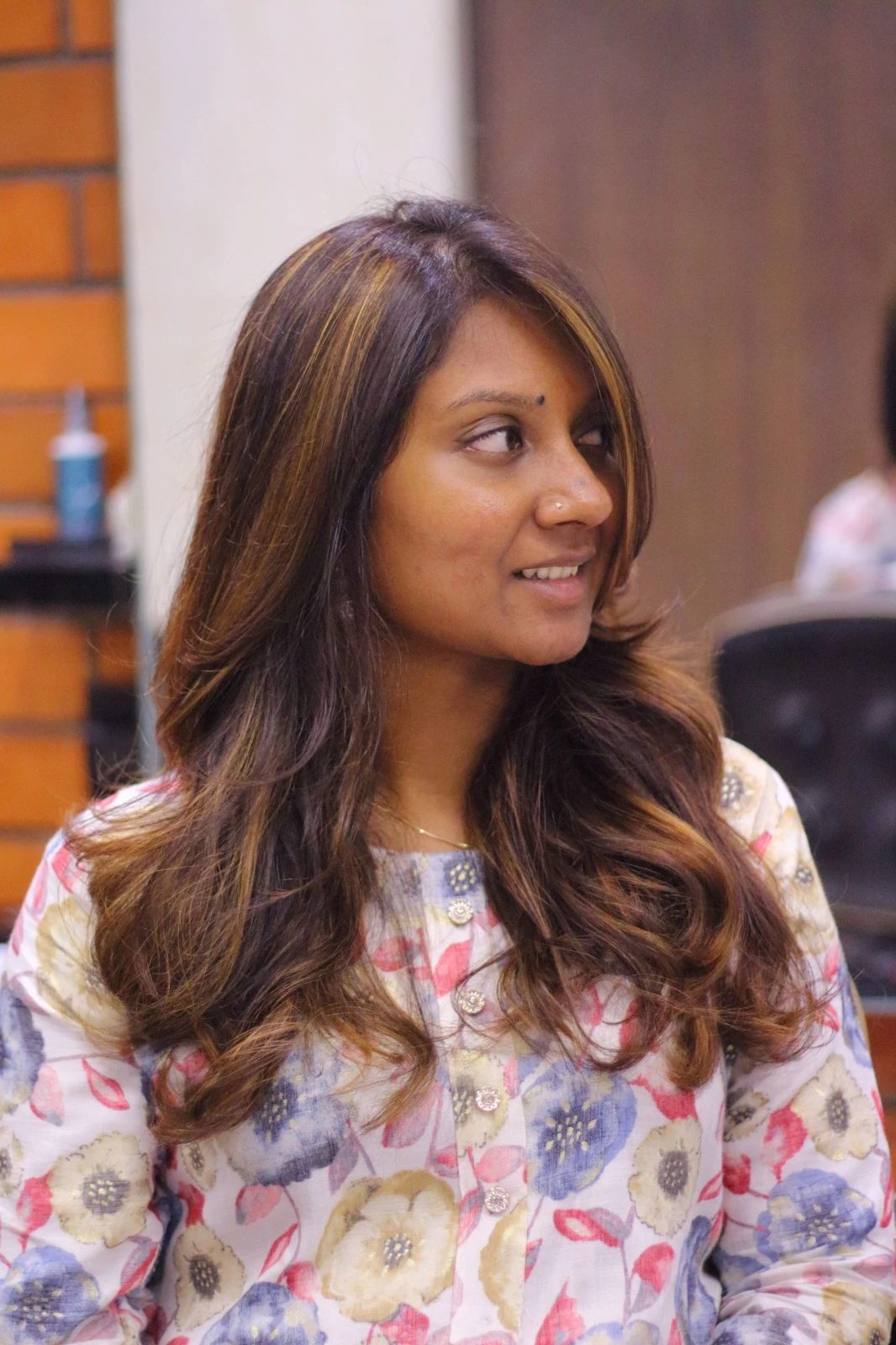 Warm caramel highlights on soft wavy hair