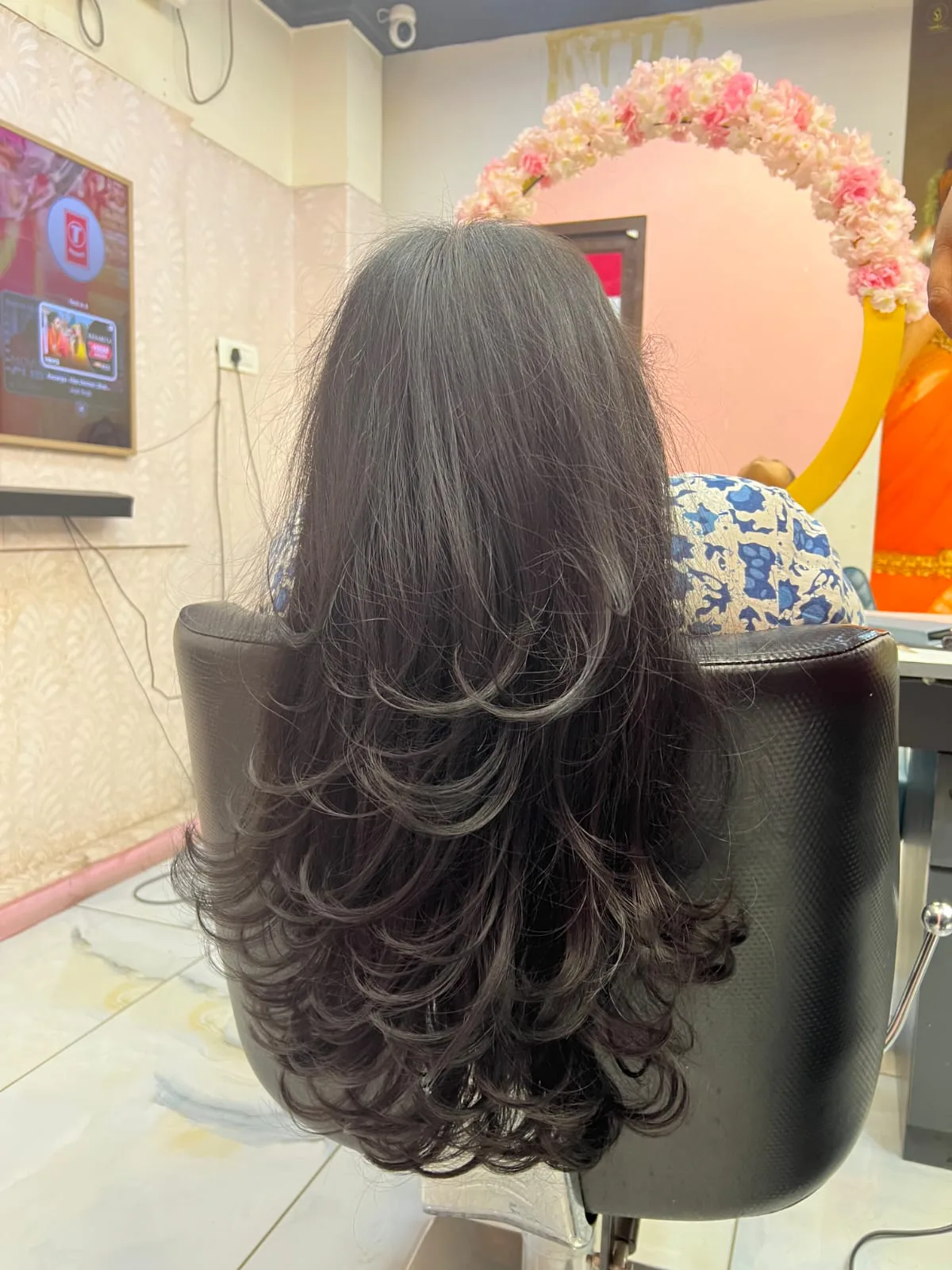 Long layered cut with a voluminous blow-dry, back view