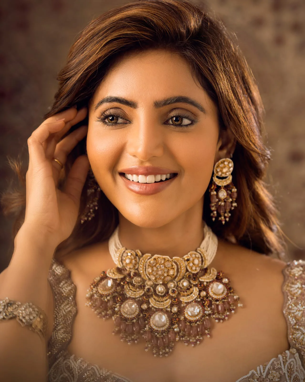 Close-up of bridal jewellery and glam makeup