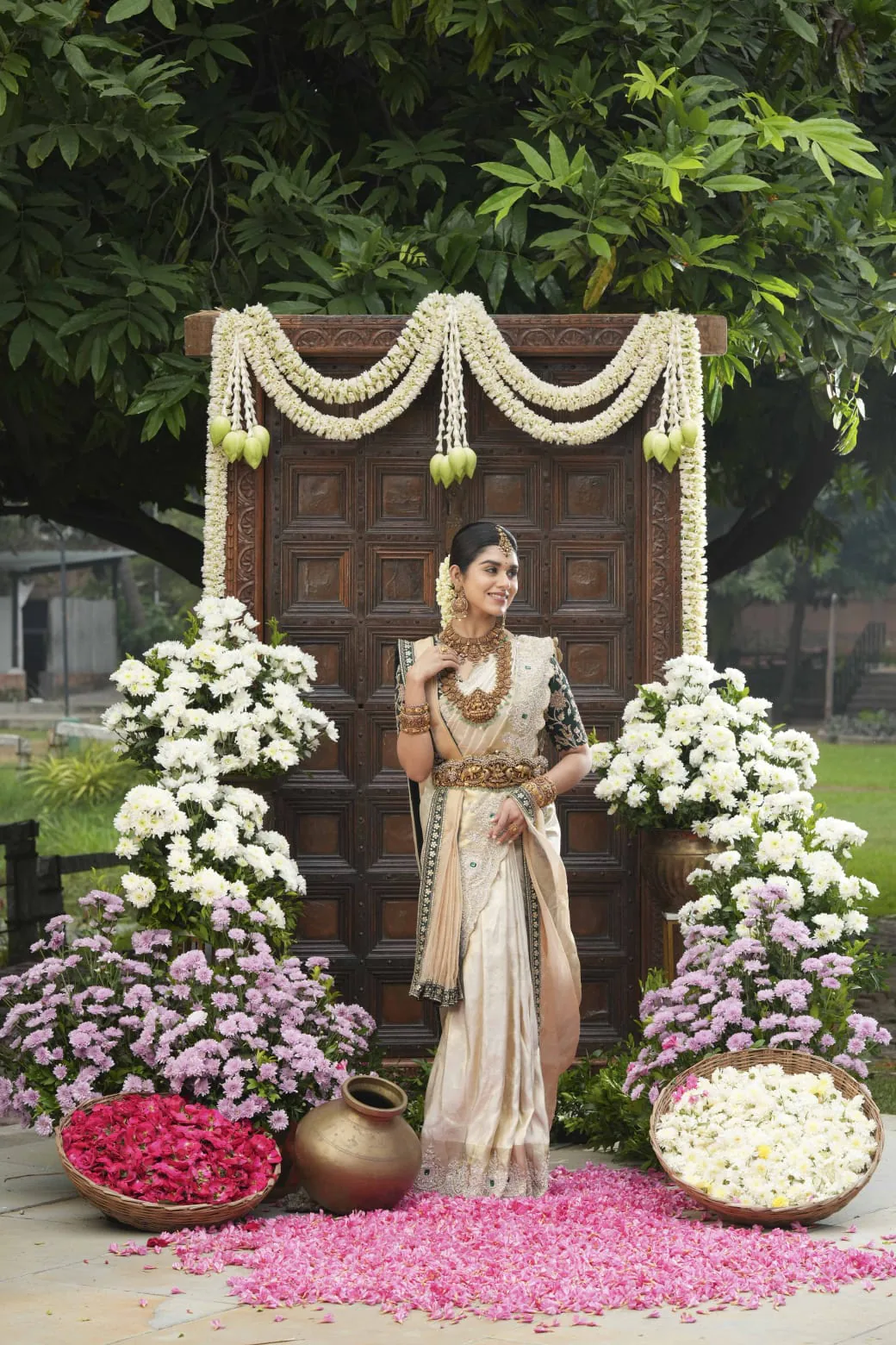 Bride seated amid elegant floral décor