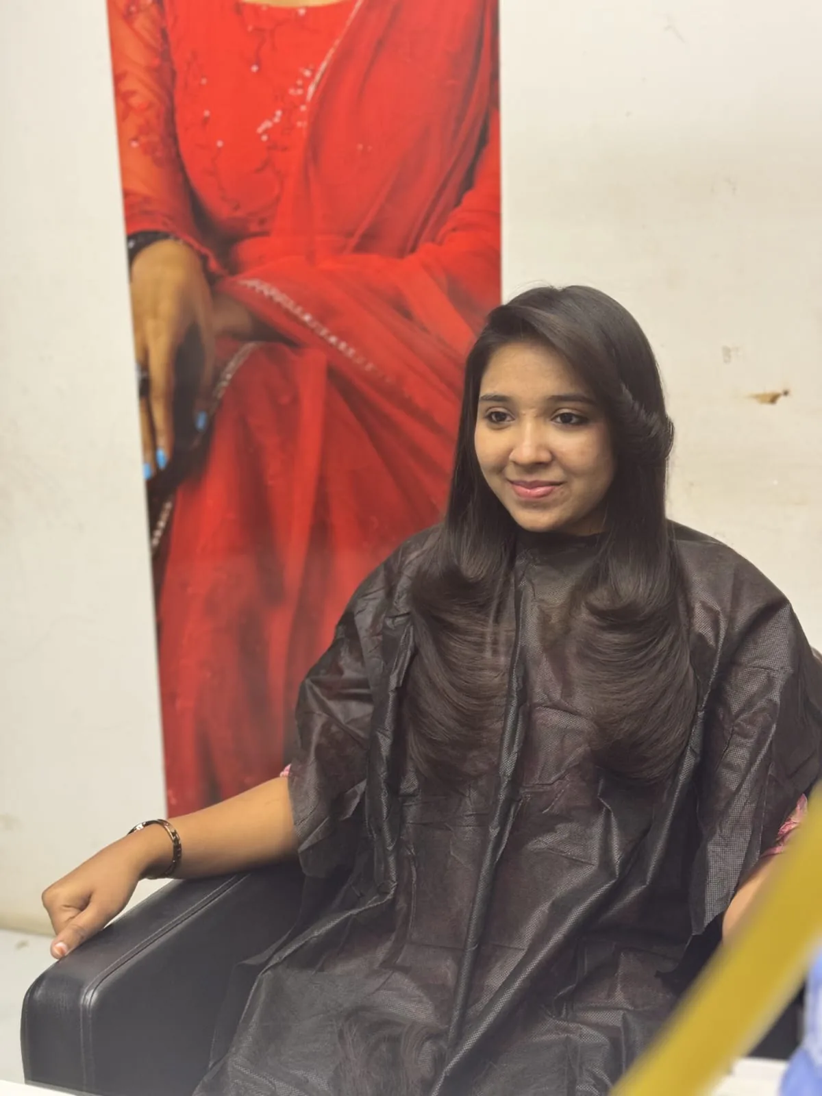Client with freshly styled hair at the salon