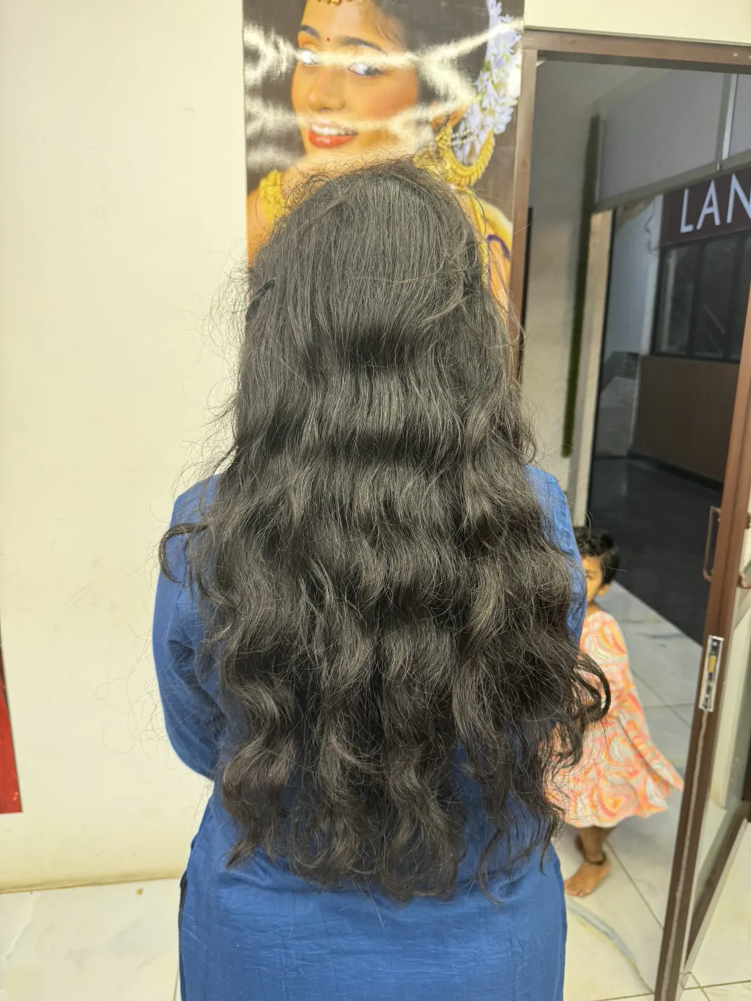 Long layered haircut with soft waves, back view